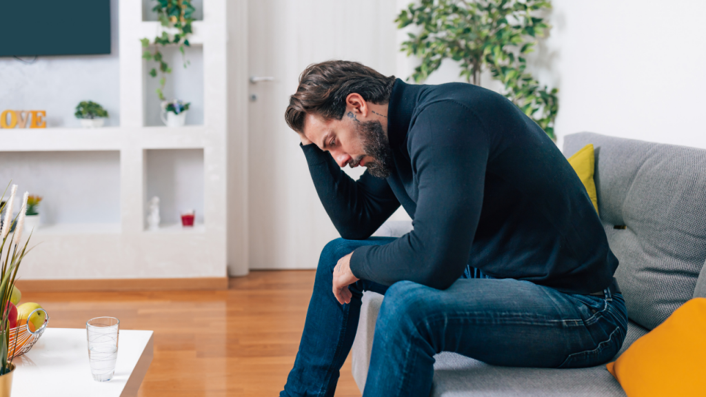 man in his chair, showing signs of depression or anxiety